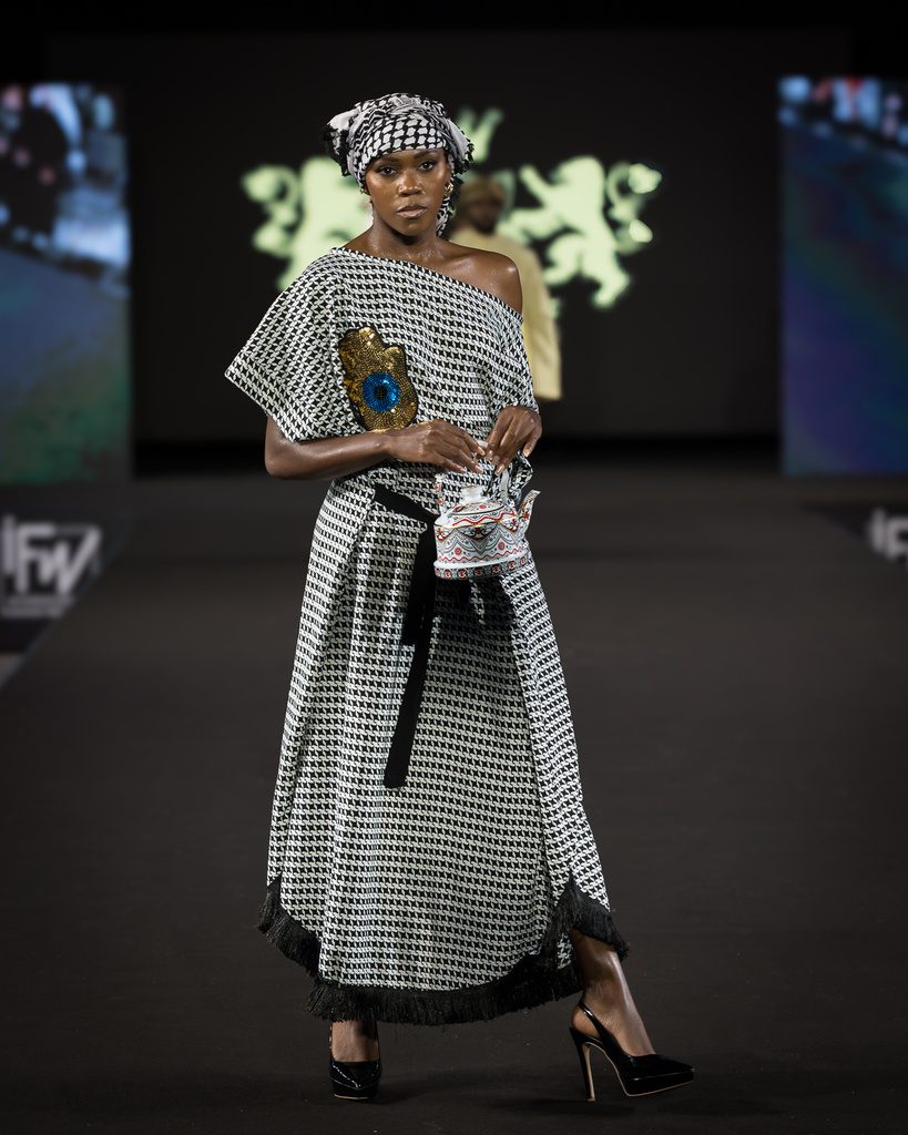 Model in a houndstooth coat with headwrap