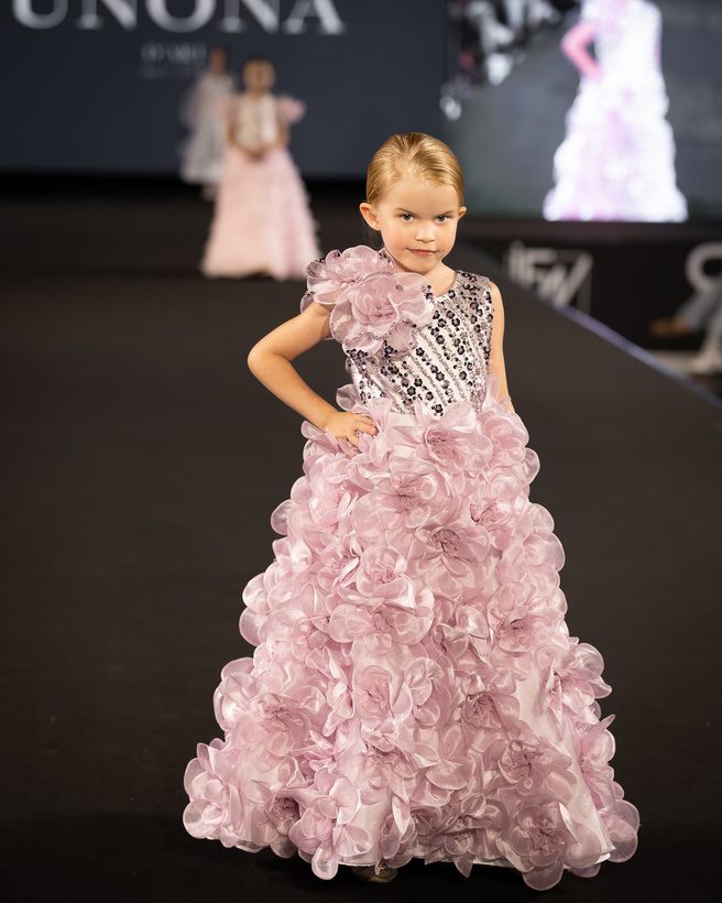 Young model in a pink ruffled gown
