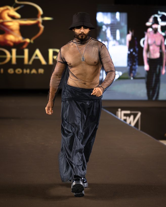 Male model in loose trousers on the runway