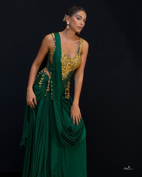 Emerald draped gown with gold embroidery