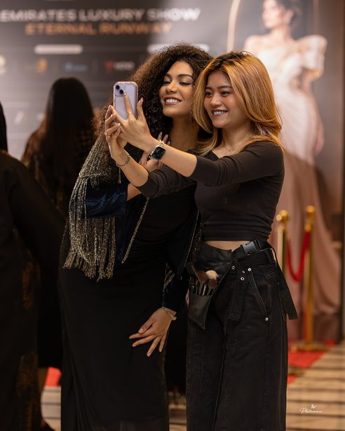 Models taking a selfie backstage